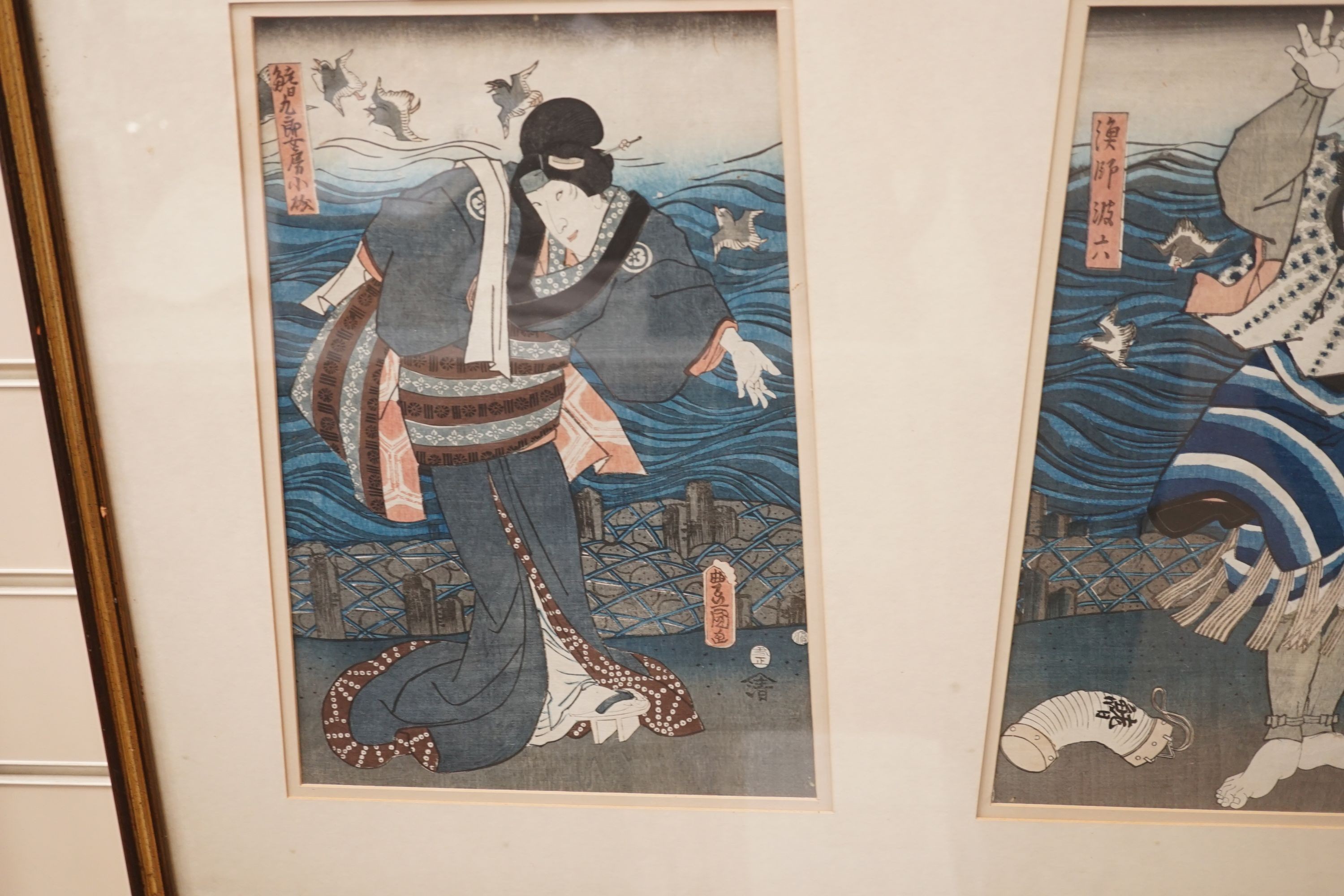 Kunisada, triptych of Japanese woodblock prints, Actors on stage beside the sea, each 35 x 24cm, framed as one